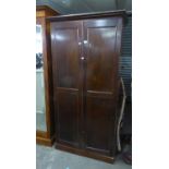 A MAHOGANY TWO DOOR WARDROBE, ENCLOSING SEVEN GRADUATED LONG DRAWERS AND AN OPEN SHELF