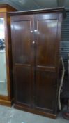 A MAHOGANY TWO DOOR WARDROBE, ENCLOSING SEVEN GRADUATED LONG DRAWERS AND AN OPEN SHELF