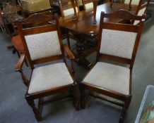 A SET OF SIX JACOBEAN STYLE CARVED OAK DINING CHAIRS WITH UPHOLSTERED BACK PANELS AND DROP IN