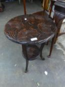 A DARK OAK OCCASIONAL TABLE, WITH CARVED FLOWER DESIGN TO THE CIRCULAR TOP AND UNDERTIER