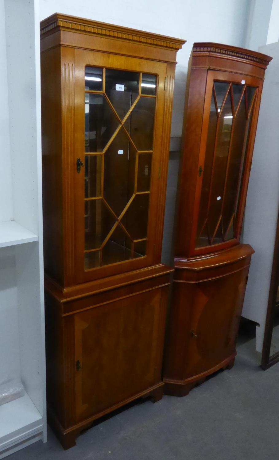 A YEW-WOOD TALL NARROW DISPLAY CABINET, THE UPPER SECTION HAVING ASTRAGAL GLAZED DOOR, ABOVE A PANEL