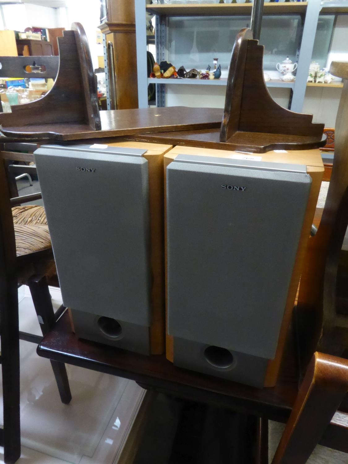 A PAIR OF SONY LOUDSPEAKERS, ON WOODEN WALL BRACKETS