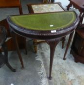 A DEMI-LUNE SIDE TABLE WITH GREEN LEATHER INSET TOP