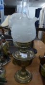 A BRASS OIL TABLE LAMP WITH FROSTED GLASS SHADE WITH FRILL TOP AND GLASS FUNNEL; ANOTHER WITH