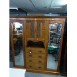 EDWARDIAN LARGE CARVED BEACONSFIELD WARDROBE, THE CENTRAL SECTION HAVING TWO SMALL CARVED DOORS OVER