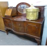 1920's MAHOGANY SIDEBOARD, THE RAISED BACK HAVING OVAL BEVELLED EDGE MIRROR, TWO BOW FRONTED