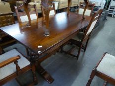 AN ELIZABETHAN STYLE CARVED OAK REFECTORY DINING TABLE, ON TWO END CUP AND COVER STANDARD AND SLEDGE
