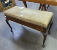 A MAHOGANY DUET STOOL WITH LIFT-UP BOX SEAT, ON FOUR ACANTHUS CARVED CABRIOLE LEGS (SEAT A.F.)