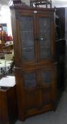 JACOBEAN STYLE OAK DOUBLE CORNER CUPBOARD, WITH A PAIR OF LEAD LIGHT DOORS OVER A PAIR OF LEAD LIGHT