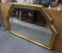 A MODERN ORNAMENTAL MIRROR WITH BEVELLED GLASS, IN GILT CAVETTO FRAME WITH STEPPED TOP