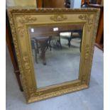 AN OBLONG WALL MIRROR, IN ORNATE CARVED WOOD GILT FRAME (89cm x 77cm)