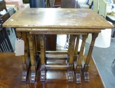 A NEST OF THREE ELM OBLONG COFFEE TABLES, ON TURNED LEGS AND SLEDGE FEET