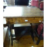 A VINTAGE WOODEN SCHOOL DESK WITH SLOPING LIFT-UP TOP, PANEL SUPPORTS, 2? WIDE