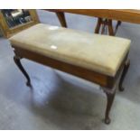 A MAHOGANY DUET STOOL WITH LIFT-UP BOX SEAT, ON FOUR ACANTHUS CARVED CABRIOLE LEGS (SEAT A.F.)