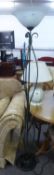 A WROUGHT IRON UPLIGHTER STANDARD LAMP AND A POTTERY TABLE LAMP AND SHADE (2)