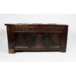 ANTIQUE CARVED OAK COFFER, the triple panel top carved with lozenge shaped motifs, set above a