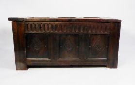 ANTIQUE CARVED OAK COFFER, the triple panel top carved with lozenge shaped motifs, set above a