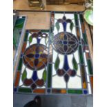 THREE EARLY TWENTIETH CENTURY LEADED AND GLAZED PANELS FOR A DOOR, FLOWERHEAD PATTERN WITH SLIP