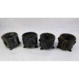 SET OF FOUR HEAVY LEAD JARDINIÈRES, cylindrical with embossed simulated mask head and ring handles