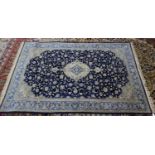 KERMAN, PERSIAN RUG, with centre medallion lozenge shaped with pendant in off-white and pale blue on
