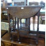 AN OAK OVAL SMALL GATE-LEG TABLE, ON TURNED LEGS, 2?5? WIDE