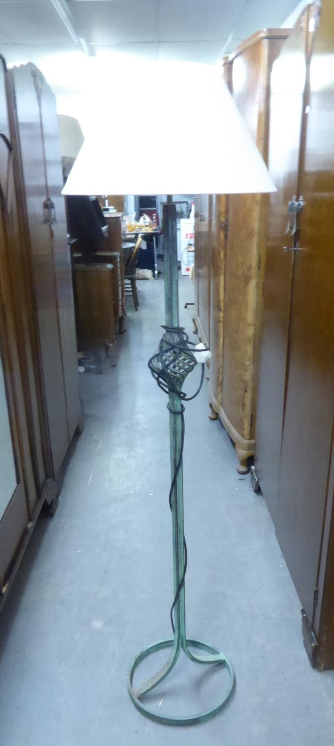 A GREEN PATINATED WROUGHT IRON STANDARD LAMP AND SHADE, A MATCHING READING LAMP AND SHADE AND A
