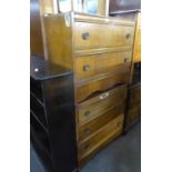 AN OAK CHEST OF  THREE LONG DRAWERS AND A DRESSING CHEST ENSUITE, WITH TWO LONG DRAWERS AND