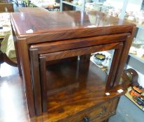 A NEST OF THREE ROSEWOOD OBLONG COFFEE TABLES, ON STRAIGHT LEGS