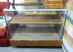 A SHOP DISPLAY CABINET WITH GLASS TOP, SIDES AND FRONT (127cm wide x 104cm high x 61cm diameter)