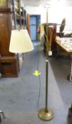 AN OXIDISED BRONZE FLOOR STANDING READING LAMP WITH ADJUSTABLE TOP, ON CIRCULAR BASE