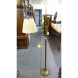 AN OXIDISED BRONZE FLOOR STANDING READING LAMP WITH ADJUSTABLE TOP, ON CIRCULAR BASE