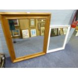 AN OBLONG WALL MIRROR IN WHITE FRAME AND A LARGE OBLONG BEVELLED EDGE WALL MIRROR IN PINE CAVETTO