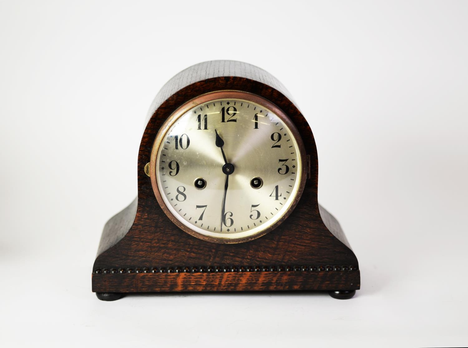 CIRCA 1920's OAK CASED NAPOLEONS HAT SHAPE MANTEL CLOCK WITH MOVEMENT STRIKING ON A COILED GONG