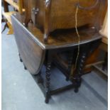 AN OAK OVAL GATE LEG DINING TABLE, ON SPIRALLY TWISTED SUPPORTS