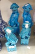 TWO PAIRS OF CHINESE BLUE GLAZED DOGS OF FO, ON SQUARE PLINTHS