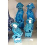 TWO PAIRS OF CHINESE BLUE GLAZED DOGS OF FO, ON SQUARE PLINTHS