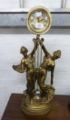 IMPRESSIVE MODERN GILT FIGURAL MANTLE CLOCK, modelled with two maidens holding aloft the drum shaped