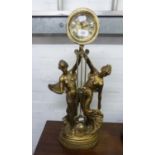 IMPRESSIVE MODERN GILT FIGURAL MANTLE CLOCK, modelled with two maidens holding aloft the drum shaped