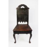 ANTIQUE CARVED OAK SIDE CHAIR, the panelled back carved with serpents and stylised foliage, and