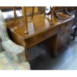 AN OAK SINGLE PEDESTAL DESK WITH TWO FRIEZE DRAWERS AND A SINGLE PEDESTAL CUPBOARD WITH COFFERED