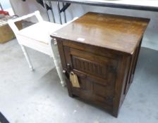 JACOBEAN STYLE CARVED OAK BEDSIDE CUPBOARD AND A WHITE PAINTED PIANO STOOL (2)