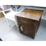 JACOBEAN STYLE CARVED OAK BEDSIDE CUPBOARD AND A WHITE PAINTED PIANO STOOL (2)