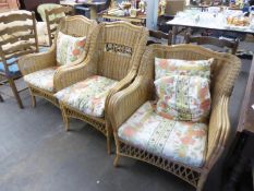 A SET OF THREE BAMBOO AND CANE CONSERVATORY ARMCHAIRS WITH LOOSE CUSHIONS