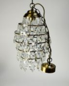 GILT METAL AND CUT GLASS LANTERN PATTERN LIGHT SHADE, with six graduated tiers, each pendant with