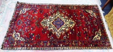 PERSIAN HAND-KNOTTED TRIBAL SMALL CARPET with large cream and blue concentric medallion and