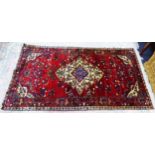 PERSIAN HAND-KNOTTED TRIBAL SMALL CARPET with large cream and blue concentric medallion and