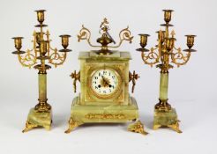 CIRCA 1900 FRENCH GREEN ONYX and GILT METAL MOUNTED CLOCK GARNITURE, the clock striking on a bell,