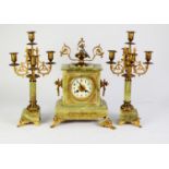 CIRCA 1900 FRENCH GREEN ONYX and GILT METAL MOUNTED CLOCK GARNITURE, the clock striking on a bell,