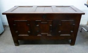 ANTIQUE OAK COFFER, the triple panelled top above a conforming front with geometric mouldings, and