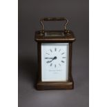 MATTHEW NORMAN BRASS CARRIAGE CLOCK, with Roman dial, oblong top glass and shaped top carrying